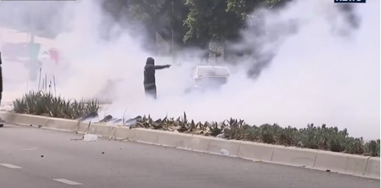 BREAKING: Protester Aims Handgun at Federal Agents in CA! —  protester confrontation California, federal agents tear gas incident, armed protest images 2025