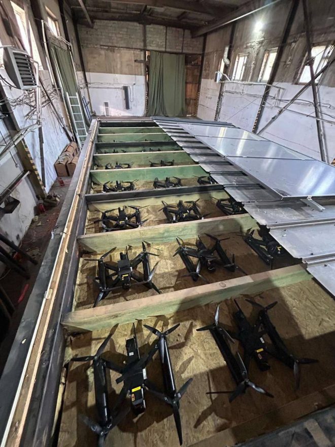 rooftops, infiltrating Russian airspace undetected. Ukraine's bold move leaves experts questioning the future of espionage tactics. — Ukraine delivery covert operation, Wooden cabins drone transport, Remote roof opening drones launch